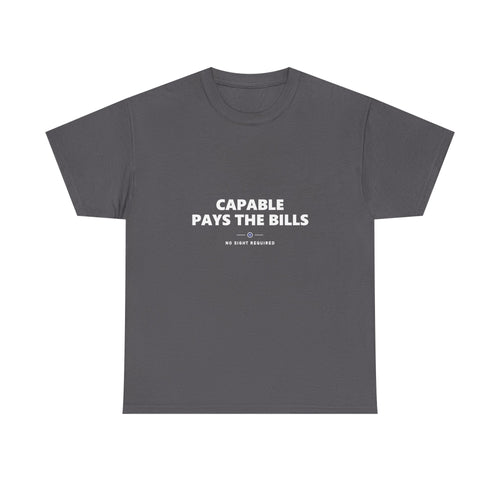 A dark t-shirt printed across the chest in large heavy white capitals on two lines: CAPABLE PAYS THE BILLS. Beneath it, two short white rules run either side of a small ring with an electric-blue inner circle and a white centre, and NO SIGHT REQUIRED sits below in small widely spaced capitals.