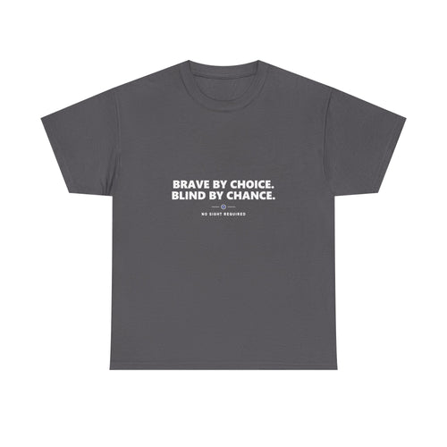 A dark t-shirt printed across the chest in large heavy white capitals on two lines: BRAVE BY CHOICE. BLIND BY CHANCE. Beneath it, two short white rules run either side of a small ring with an electric-blue inner circle and a white centre, and NO SIGHT REQUIRED sits below in small widely spaced capitals.